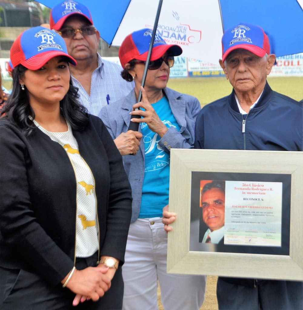 Katty Espinal viuda Rodríguez entrega una placa de reconocimiendo a don José Sesé Rodríguez
