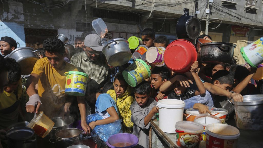 Palestinos se agolpan mientras esperan la distribucion de alimentos en Rafa en el sur de la Franja de Gaza